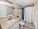 Updated bathroom with a white vanity, modern fixtures, and a shower with a blue tile backsplash at 25050 Sandhill Blvd # 6A3, Punta Gorda, FL 33983