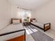 Bright bedroom with two twin beds, a center table, and large window letting in natural light at 25050 Sandhill Blvd # 6A3, Punta Gorda, FL 33983
