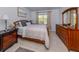 Spacious bedroom featuring a comfy bed, tile flooring, and bedside tables with lamps at 25050 Sandhill Blvd # 6A3, Punta Gorda, FL 33983