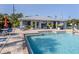 Community pool with a clear blue pool, lounge seating, and a nearby clubhouse at 25050 Sandhill Blvd # 6A3, Punta Gorda, FL 33983