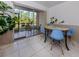Bright dining area with views of the screened-in patio and lovely tile flooring at 25050 Sandhill Blvd # 6A3, Punta Gorda, FL 33983