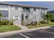 This two-story condo features a white staircase leading to the upper units and manicured landscaping at 25050 Sandhill Blvd # 6A3, Punta Gorda, FL 33983