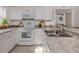 Bright kitchen featuring an oven and microwave combo, neutral countertops and white cabinets at 25050 Sandhill Blvd # 6A3, Punta Gorda, FL 33983
