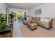 Open living space with decorative rug, large sofa, decor, tile flooring and sliding doors to balcony at 25050 Sandhill Blvd # 6A3, Punta Gorda, FL 33983