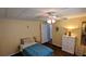 Cozy bedroom featuring a ceiling fan, and a comfortable bed with blue covers at 310 Tropic Dr, Osprey, FL 34229