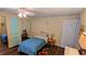 Simple bedroom with wood-look flooring, closet, and a comfortable bed covered in blue at 310 Tropic Dr, Osprey, FL 34229