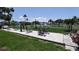Outdoor exercise area with a variety of workout equipment, pond view, and beautiful landscaping at 310 Tropic Dr, Osprey, FL 34229