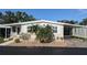 Charming single-story home featuring a covered carport and neat landscaping at 310 Tropic Dr, Osprey, FL 34229