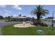 Charming home exterior with a well-manicured lawn, a decorative fountain, and lush landscaping at 310 Tropic Dr, Osprey, FL 34229