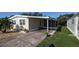 Exterior shot showing covered carport and screened in patio of home at 310 Tropic Dr, Osprey, FL 34229