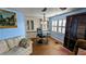 This living room has a glass table, white cabinets and shuttered windows for natural light at 310 Tropic Dr, Osprey, FL 34229