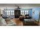 Cozy living room featuring light blue walls, plank flooring, and comfortable seating arrangement at 310 Tropic Dr, Osprey, FL 34229