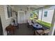 Relaxing screened patio with comfortable seating and decorative furnishings at 310 Tropic Dr, Osprey, FL 34229