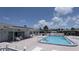 Large community swimming pool surrounded by ample seating, a fence and well-maintained deck at 310 Tropic Dr, Osprey, FL 34229