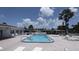 Inviting community pool area with ample seating and manicured landscaping under a sunny sky at 310 Tropic Dr, Osprey, FL 34229
