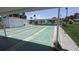 Recreational shuffleboard courts with shaded pavilions, green space, and the community in the background at 310 Tropic Dr, Osprey, FL 34229