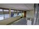 Enclosed sunroom featuring multiple windows and a carpeted floor at 310 Tropic Dr, Osprey, FL 34229