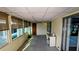Bright sunroom with multiple windows and a small desk area at 310 Tropic Dr, Osprey, FL 34229
