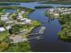 Aerial shot of a waterfront community, featuring private boat docks, and lakefront pond with fountain at 349 Mariner Dr, North Port, FL 34287