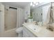 Well-lit bathroom featuring a tub with shower and a bright vanity with decorative accents at 349 Mariner Dr, North Port, FL 34287
