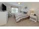 Cozy bedroom features a comfortable bed, side tables, a rocking chair, and plenty of natural light at 349 Mariner Dr, North Port, FL 34287
