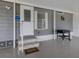 Covered carport area with exterior door, steps to the main entrance, and room for outdoor seating at 349 Mariner Dr, North Port, FL 34287
