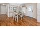 Bright dining room featuring wood floors, a white table with four chairs, and built-in cabinets for storage at 349 Mariner Dr, North Port, FL 34287