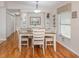 Dining room with light-colored wood flooring, a white table, neutral-toned chairs, and natural light from a window at 349 Mariner Dr, North Port, FL 34287