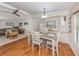 An open-concept dining area with a ceiling fan and wood floors adjoining a living room with comfortable seating at 349 Mariner Dr, North Port, FL 34287