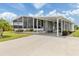 Charming single-story home featuring a covered front porch, screened-in lanai, and landscaped yard at 349 Mariner Dr, North Port, FL 34287