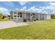 Well-maintained home exterior with a spacious carport, covered entrance, and beautiful landscaping at 349 Mariner Dr, North Port, FL 34287