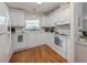 Bright kitchen features all white cabinetry and appliances, with a window providing natural light above the sink at 349 Mariner Dr, North Port, FL 34287