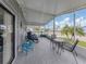 Spacious screened lanai offers comfortable seating and a view of the neighborhood at 349 Mariner Dr, North Port, FL 34287