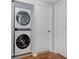 Convenient in-home laundry closet features a stacked washer and dryer unit, and ample storage space at 349 Mariner Dr, North Port, FL 34287