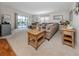 Inviting living room area with comfortable seating, stylish décor, and a sliding door to an outdoor patio at 349 Mariner Dr, North Port, FL 34287