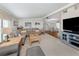 Spacious living room area seamlessly connecting to the dining space, featuring cozy seating and bright lighting at 349 Mariner Dr, North Port, FL 34287