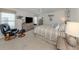 A main bedroom featuring a neutral color palette, ceiling fan, carpeted floors, and a comfortable reading chair at 349 Mariner Dr, North Port, FL 34287