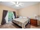 Main bedroom features large windows, balcony access, and neutral decor at 3613 Parkridge Cir # 11-201, Sarasota, FL 34243