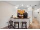 Kitchen view showcasing ample bar seating, hardwood cabinets and black appliances at 3613 Parkridge Cir # 11-201, Sarasota, FL 34243