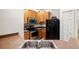 Kitchen featuring stainless steel oven, dark appliances, and light wood cabinets at 3613 Parkridge Cir # 11-201, Sarasota, FL 34243