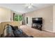 Upstairs living room area features a sliding glass door to a balcony and plenty of natural light at 3613 Parkridge Cir # 11-201, Sarasota, FL 34243