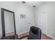 Neutral toned office space featuring a large mirror, two doors, and a comfortable desk chair at 3613 Parkridge Cir # 11-201, Sarasota, FL 34243
