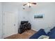 Bright room featuring a futon sofa, computer desk, and natural light through a window at 3613 Parkridge Cir # 11-201, Sarasota, FL 34243