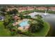 Aerial view of community in-ground pool with lounge furniture, a gazebo, a fountain, landscaping, and beautiful lakes at 3613 Parkridge Cir # 11-201, Sarasota, FL 34243