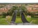 Aerial view of a beautiful community entrance featuring landscaping, fountains, and multiple townhome buildings at 3613 Parkridge Cir # 11-201, Sarasota, FL 34243