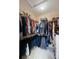 Organized walk-in closet with ample storage and custom shelving at 3613 Parkridge Cir # 11-201, Sarasota, FL 34243