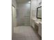 Well-lit bathroom featuring white cabinets, dual sinks, shower, and a toilet room, creating a functional space at 3790 Cadbury Cir # 40, Venice, FL 34293