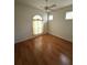 Serene bedroom with hardwood floors, neutral walls, a ceiling fan, and ample natural light, creating a calming atmosphere at 3790 Cadbury Cir # 40, Venice, FL 34293