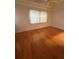 Inviting bedroom with hardwood floors, a large window, and a ceiling fan, offering a comfortable and relaxing retreat at 3790 Cadbury Cir # 40, Venice, FL 34293