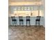 Kitchen bar features seating for four and glass front cabinets above, creating an inviting space at 3790 Cadbury Cir # 40, Venice, FL 34293